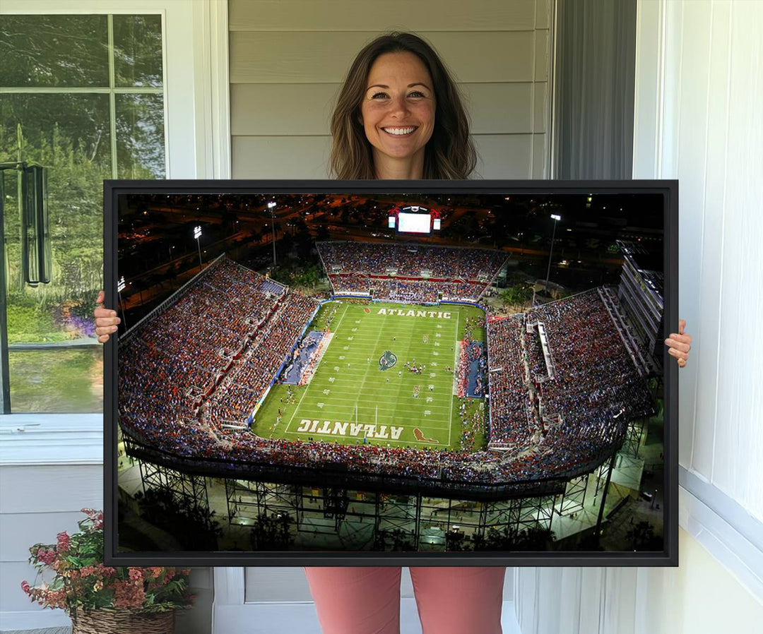 Gallery-quality wall art complements the view of the FAU Stadium with Florida Atlantic University Owls on the field in a night aerial setting.