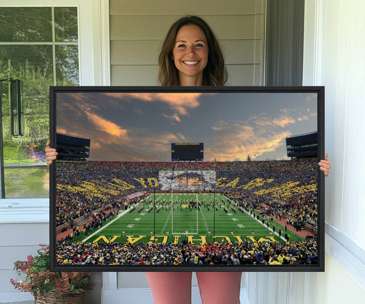 A giant image resembling Michigan Wolverines Wall Art depicts a football field beneath a dramatic sky.