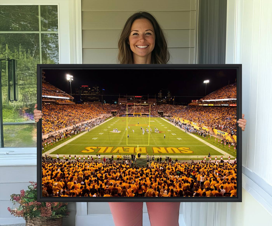 The Phoenix Stadium Canvas Wall Art features a vibrant depiction of a packed stadium filled with ASU Sun Devils fans wearing yellow shirts.