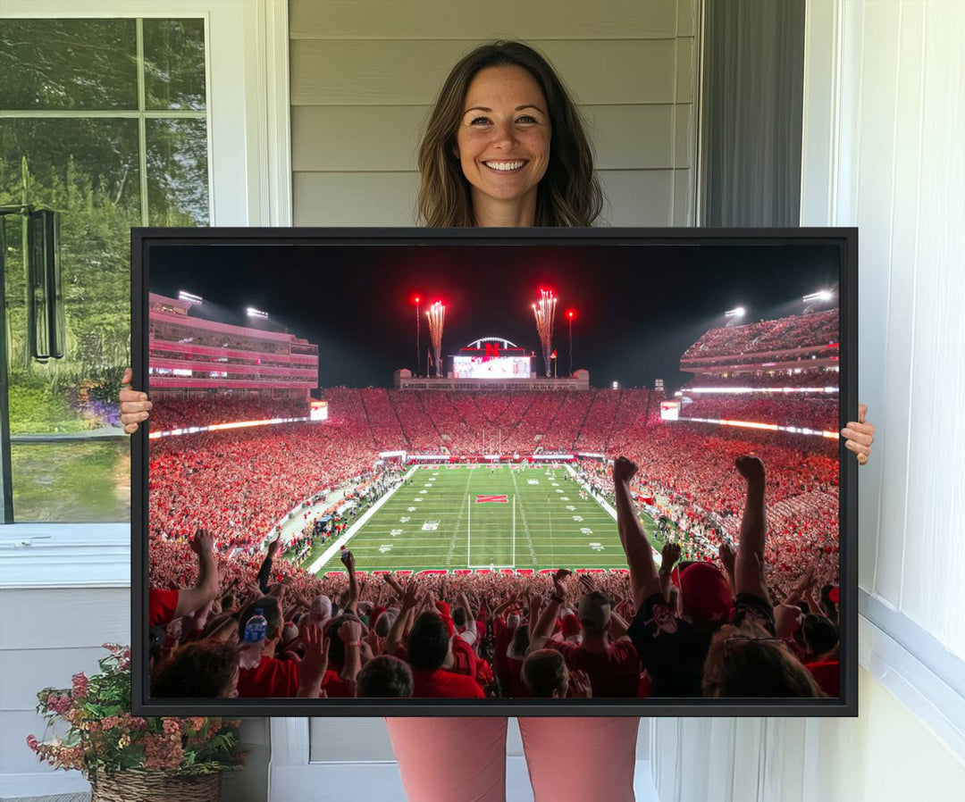 A vibrant canvas print of the Lincoln Memorial Stadium at night with fireworks, featuring the University of Nebraska Cornhuskers Football.