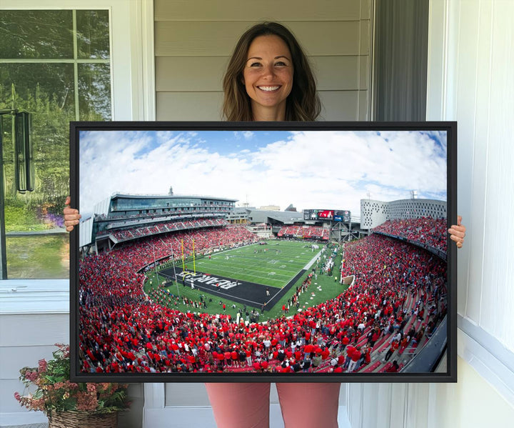 The wall showcases a Nippert Stadium canvas print of the Cincinnati Bearcats.