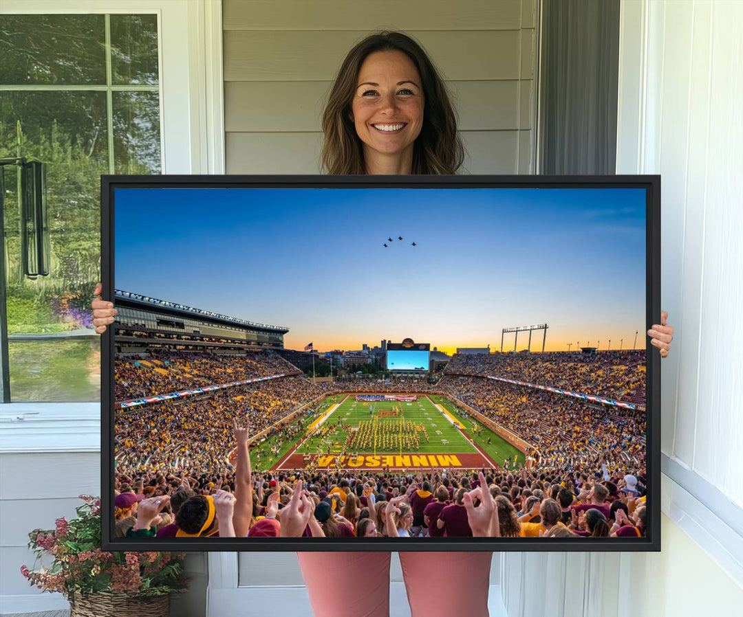 Canvas wall art featuring the University of Minnesota Football Team print, showcasing Huntington Bank Stadium at sunset with jets overhead.