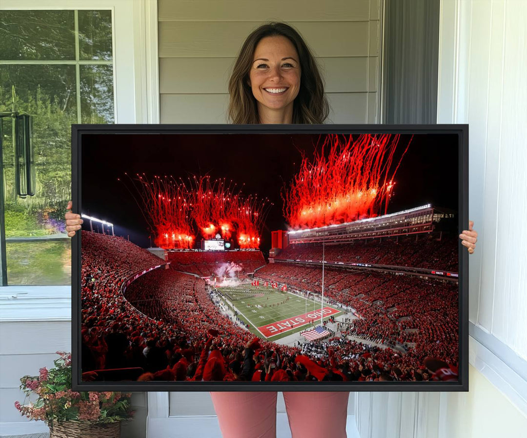 A vibrant red canvas art of a packed Ohio State Buckeyes stadium at night with fireworks.