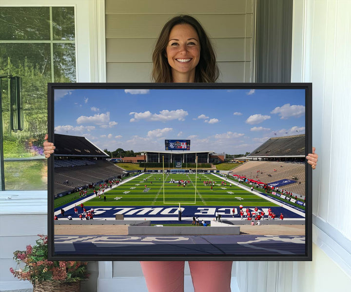 Rice Stadium print: This artwork features a football field with empty stands and a gallery-quality finish under a clear blue sky.