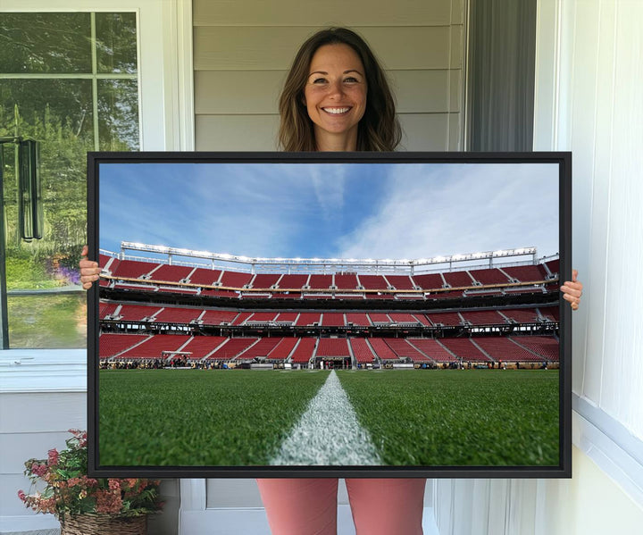 A canvas print of the University of Tulsa Golden Hurricane showcases H.A. Chapman Stadiums football field and red seats against a backdrop of a blue sky.