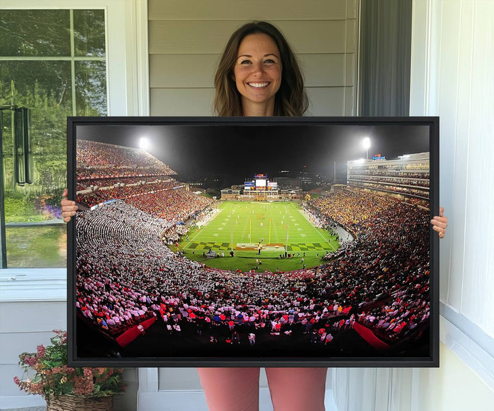 The Maryland Terrapins Football Wall Art Canvas showcases a packed SECU Stadium at night with a bright field and cheering fans.