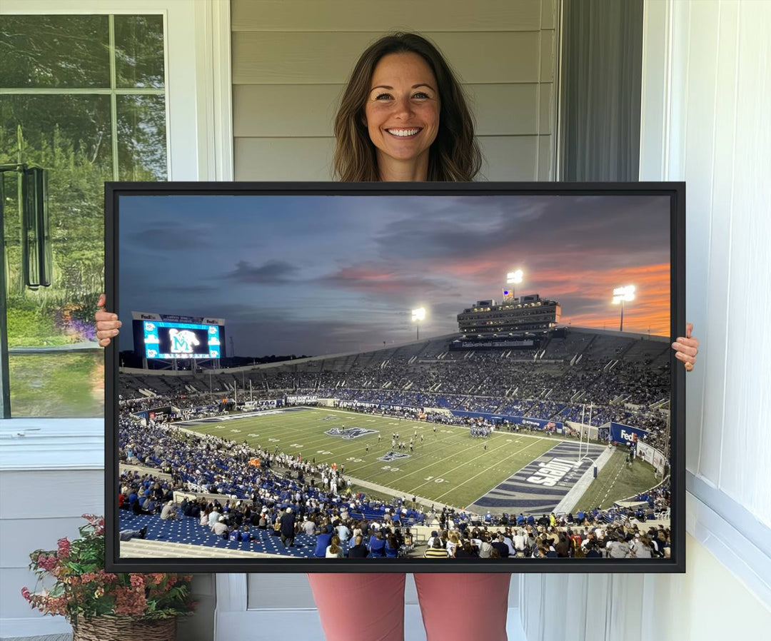 A Memphis Tigers football canvas print of Simmons Bank Liberty Stadium at sunset enhances the living room.