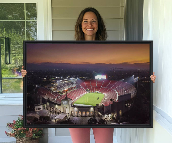 The USC Trojans Stadium canvas captures Memorial Coliseum at twilight, showcasing red seats and a green field beneath an orange sky.