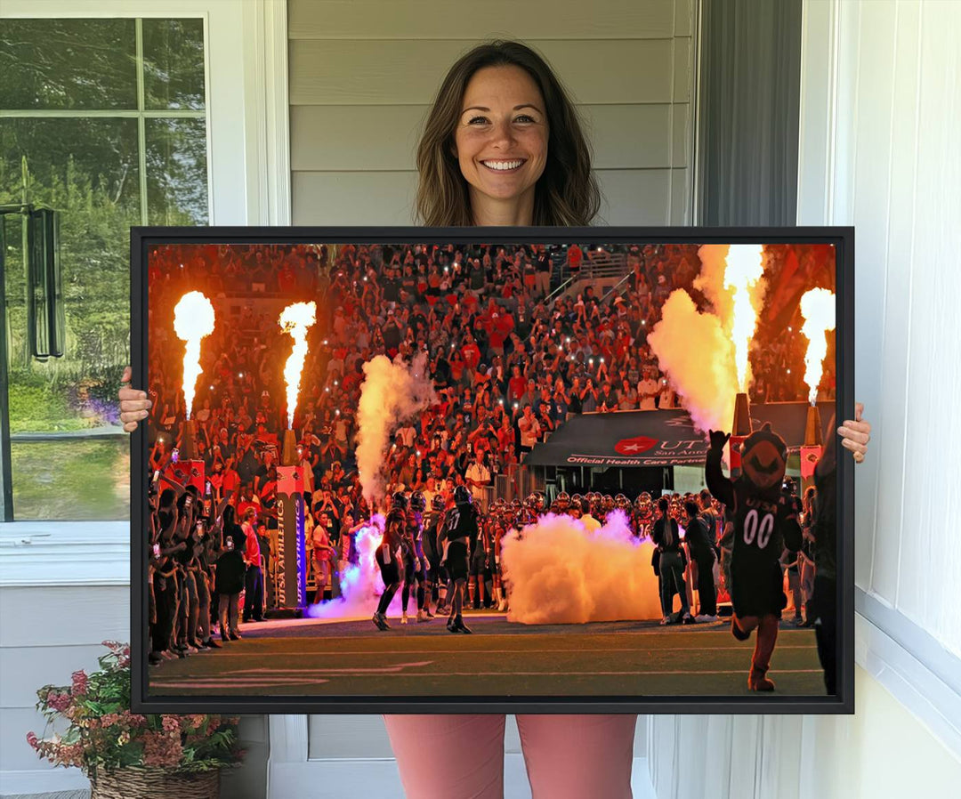 This canvas print captures the UTSA Roadrunners storming the Alamodome under smoke and fire.