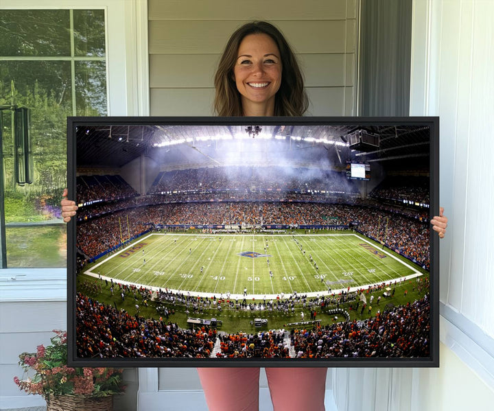 The modern living room features an Alamodome wall art canvas print, depicting a stadium filled with spectators for a UTSA Roadrunners game.