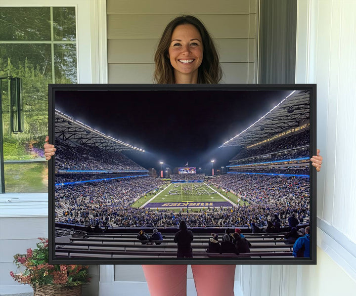 A canvas print titled The University of Washington Huskies Football depicts a packed Husky Stadium at night, as seen from the stands.