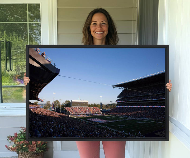 The University of Washington Huskies wall art print depicts Husky Stadium coming alive with fans as flags flutter.