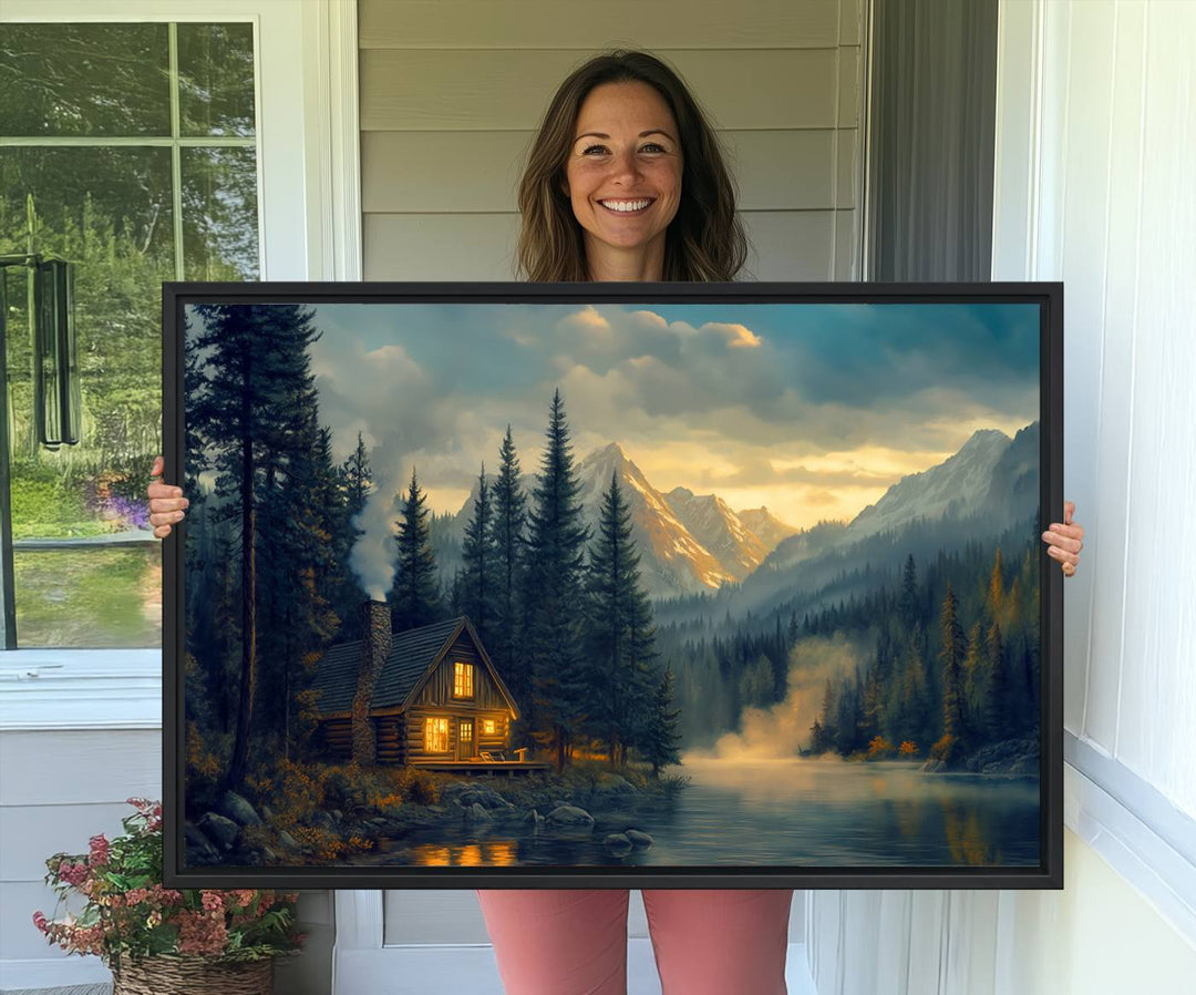 Serene sunset lake wall art: a cozy mountain cabin with lights, framed by pine trees and set against a moody sky. Ideal for adding rustic lodge charm to your space.