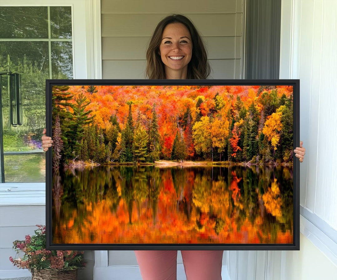 Autumn Forest Reflection Wall Art: a vibrant triptych canvas featuring fall foliage with red, orange, and yellow leaves over a calm lake.