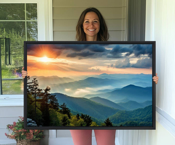 The wall art, titled Sunrise Over Mountain Range, is a canvas print that beautifully depicts layers of hills, scattered trees, and a partly cloudy sky.