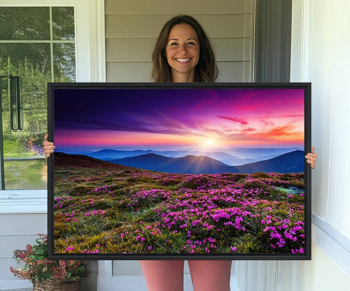 A 3-panel landscape photography canvas of a sunset over mountain meadows with purple wildflowers decorates the wall.