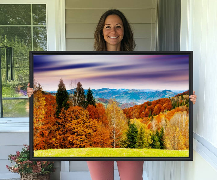 The wall art in the kitchen dining area is a large Autumn Forest Mountain Canvas Print that captures a vivid scenic landscape.
