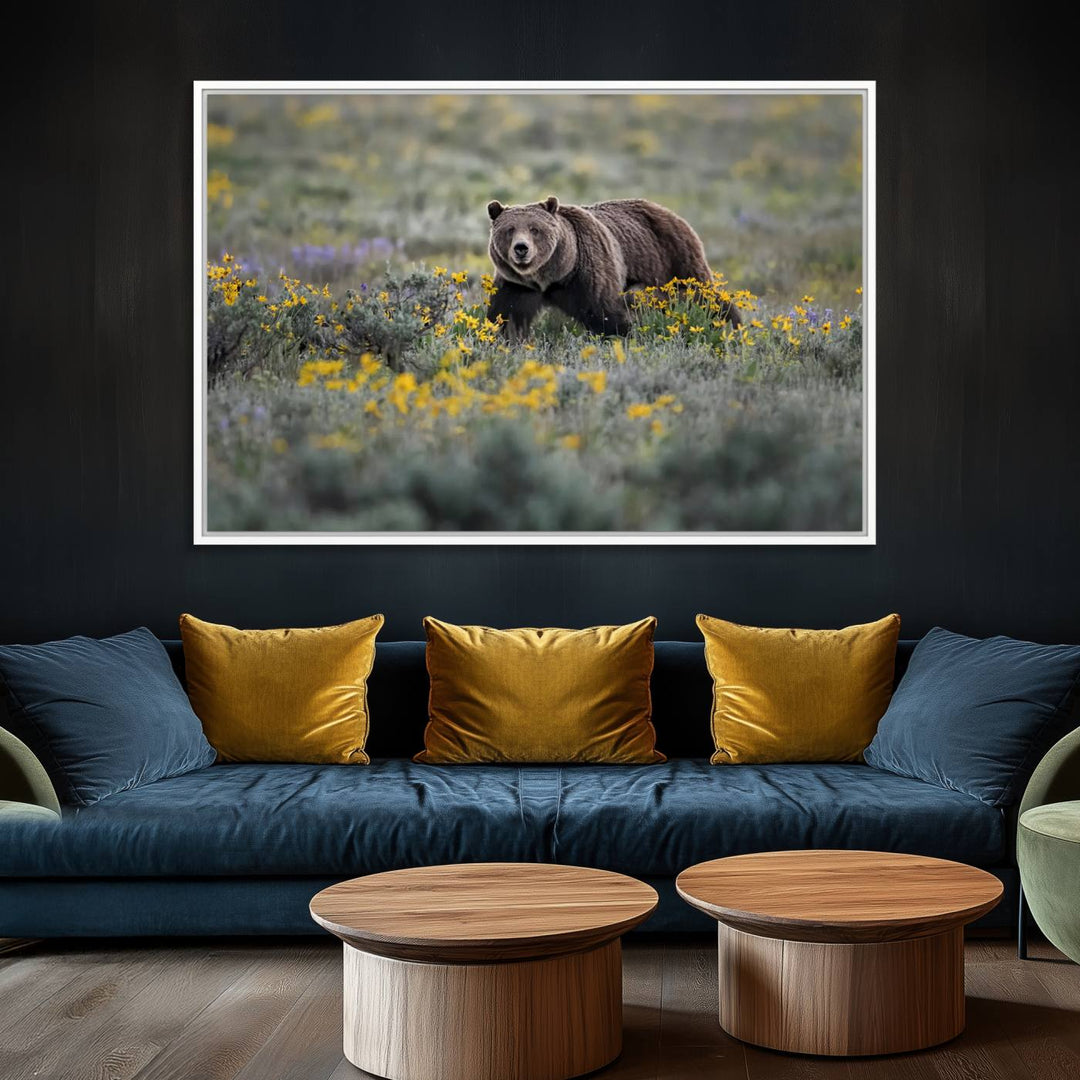 The "Grizzly 399 in Wild Flowers Wall Art Canvas Print" features a grizzly bear strolling through a field of yellow and purple flowers, beautifully showcased as a triptych. This handcrafted piece, proudly made in the USA, adds charm and sophistication to your space.