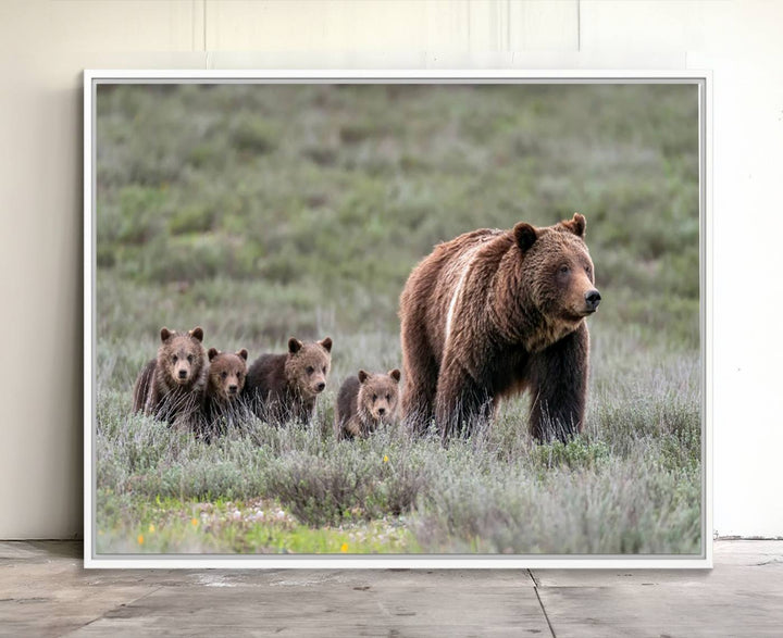 The large canvas print titled "Queen of the Tetons, 399 Grizzly Bear Cubs" showcases majestic wildlife photography of a bear and her cubs walking through the grass. This stunning canvas wall art, handmade in the USA, adds a charming touch to any room with its rustic decor appeal.