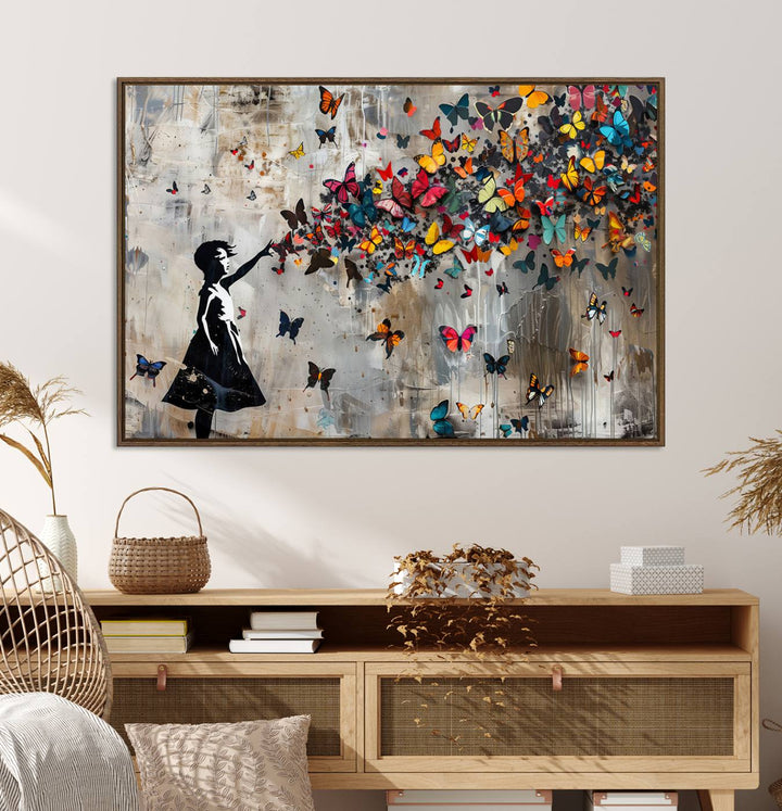 The Banksy Butterfly Girl 3-Piece Modern Graffiti Canvas Wall Art features a silhouette of a girl reaching for butterflies.