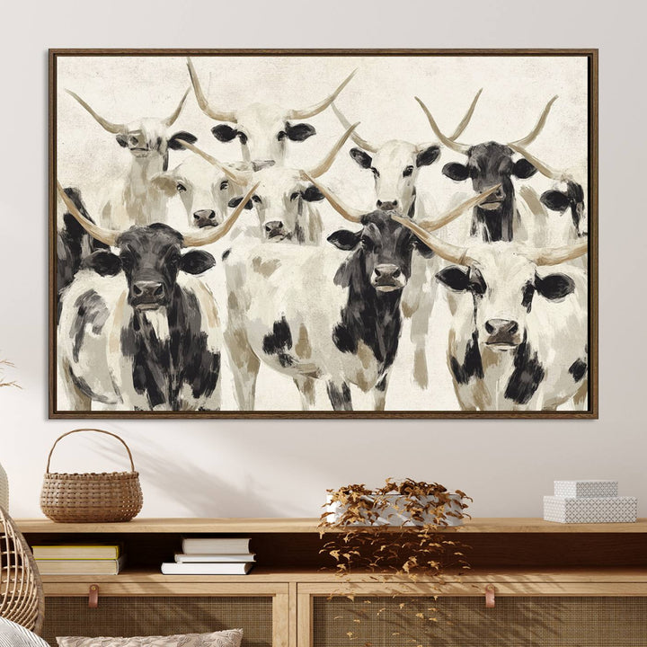 Canvas print titled Longhorn Texas Cow Drawing, depicting longhorn cattle with black and white markings, made in the USA, displayed on the wall.