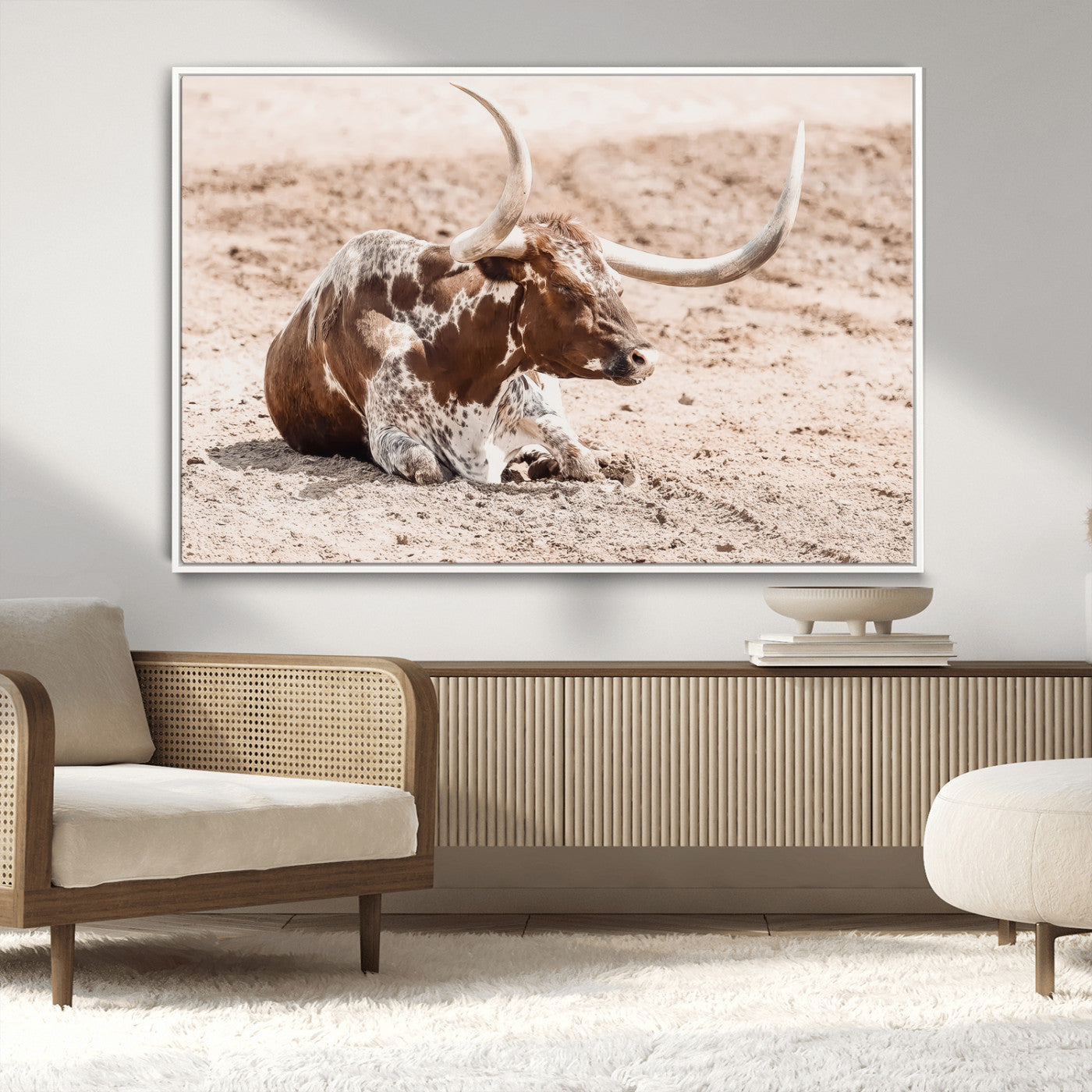 Texas Longhorn bull resting on dusty ground with warm tones, ideal for rustic western or farmhouse-themed wall decor.