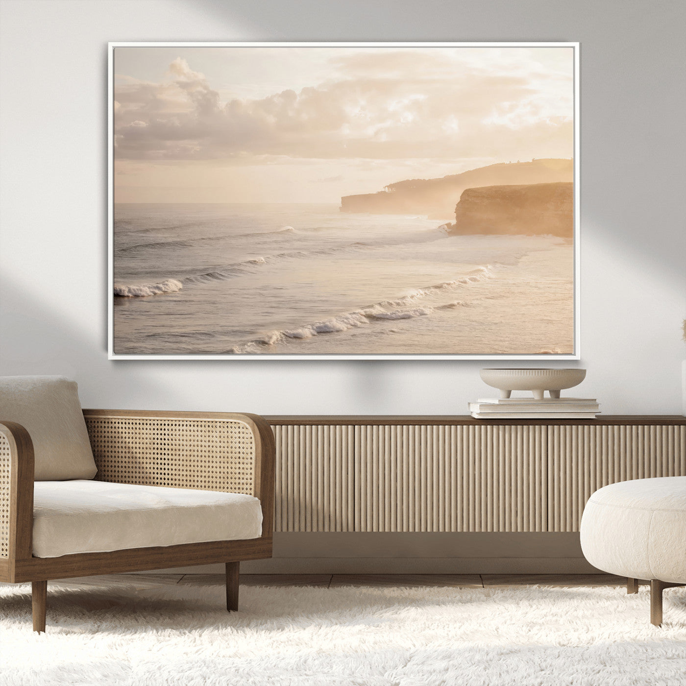 Golden hour seascape with misty cliffs and gentle waves rolling towards the shore, capturing a tranquil and warm coastal atmosphere.