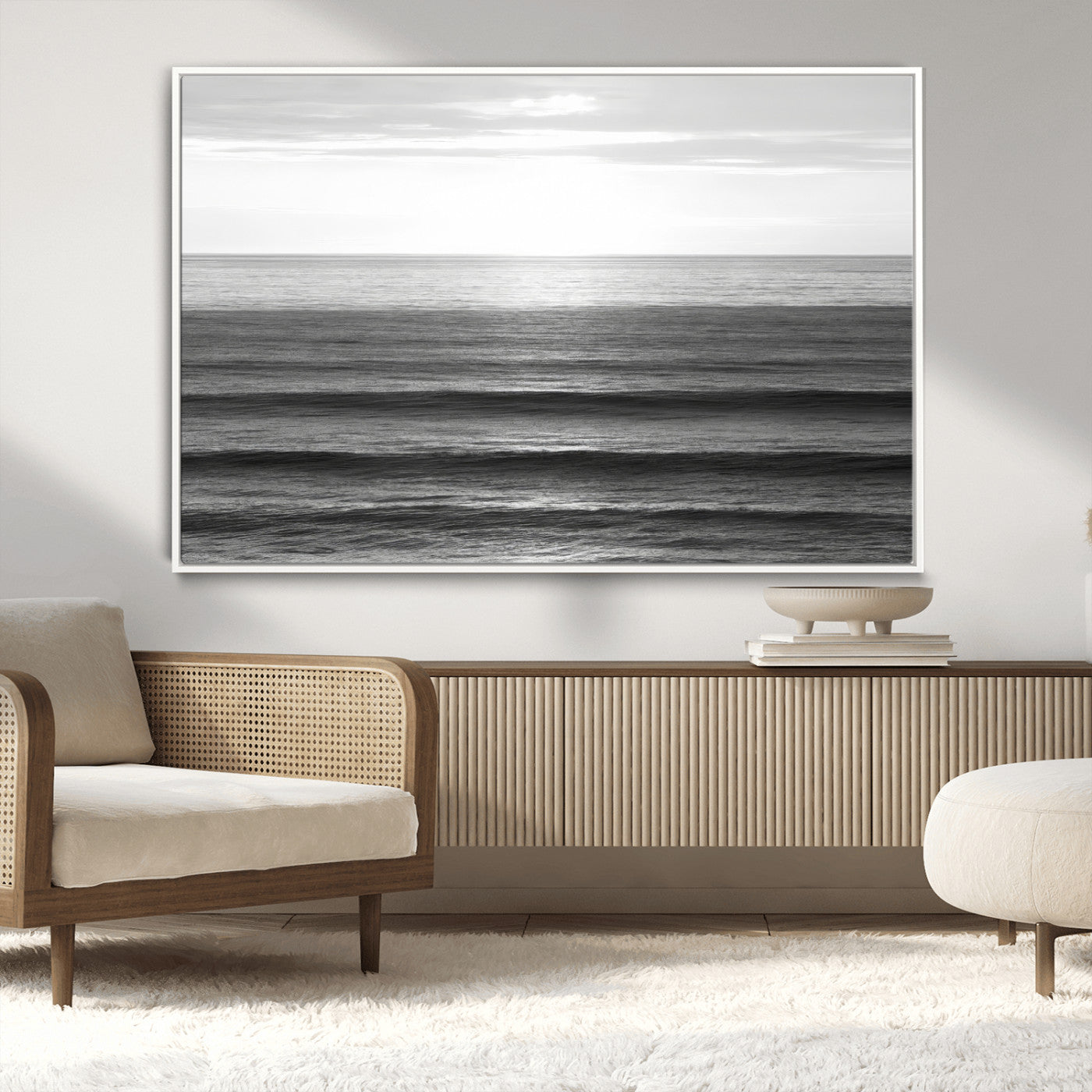 Minimalist black and white ocean view with layered waves reflecting sunlight, evoking a sense of calm and coastal serenity.