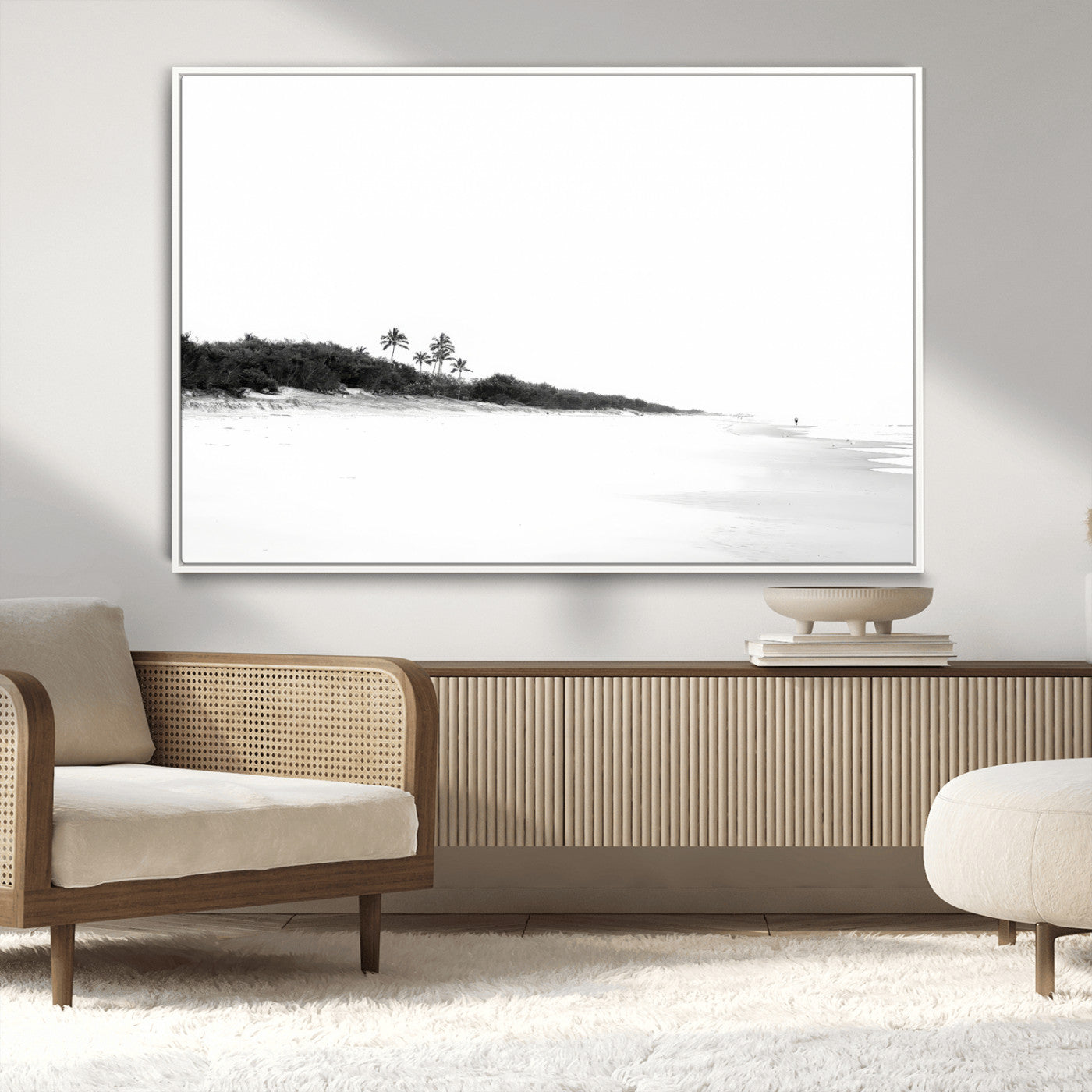 A black and white minimalist coastal scene with a vast open beach, distant palm trees, and a lone figure walking along the shoreline, evoking serenity and solitude.