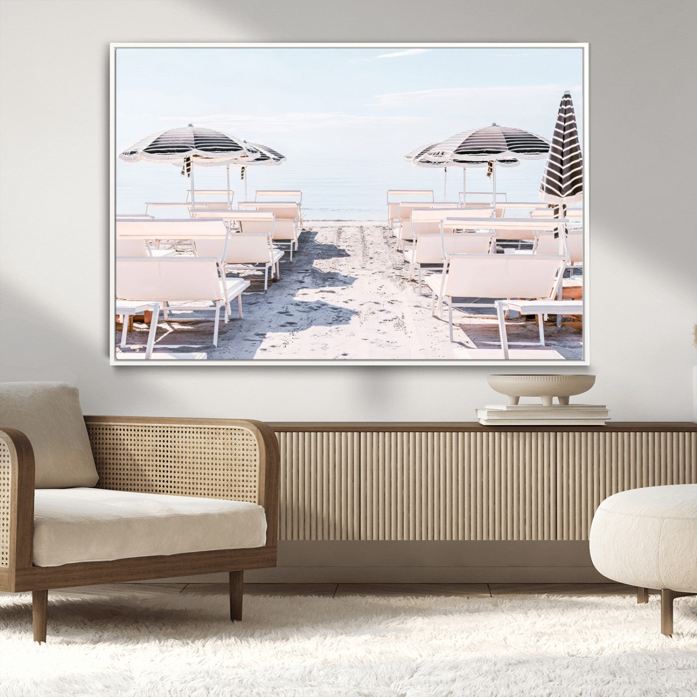 A serene minimalist beach scene featuring striped umbrellas, soft pastel sand, and an elegant lounge setup, creating a tranquil and stylish coastal retreat.