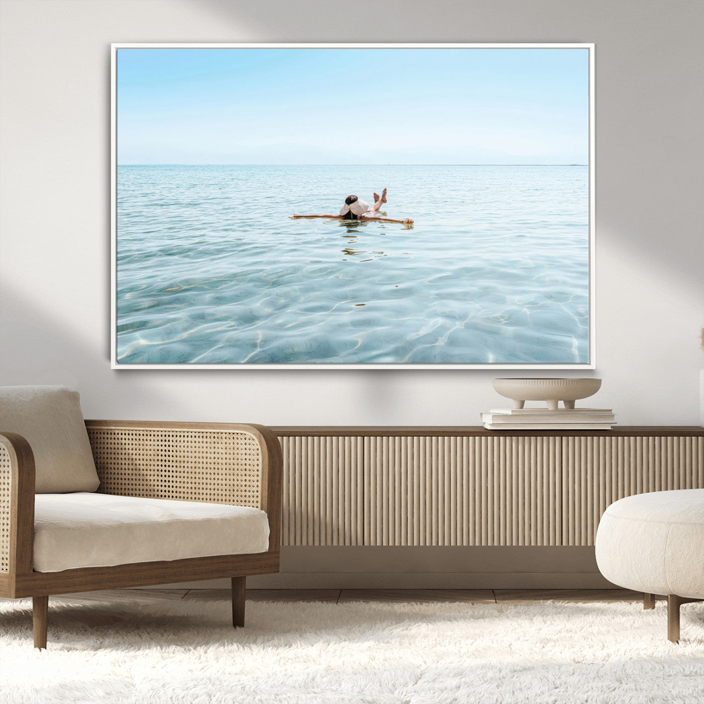 A peaceful minimalist scene of a person floating on crystal-clear water, surrounded by a vast open horizon, capturing relaxation and serenity in a tranquil aquatic setting.