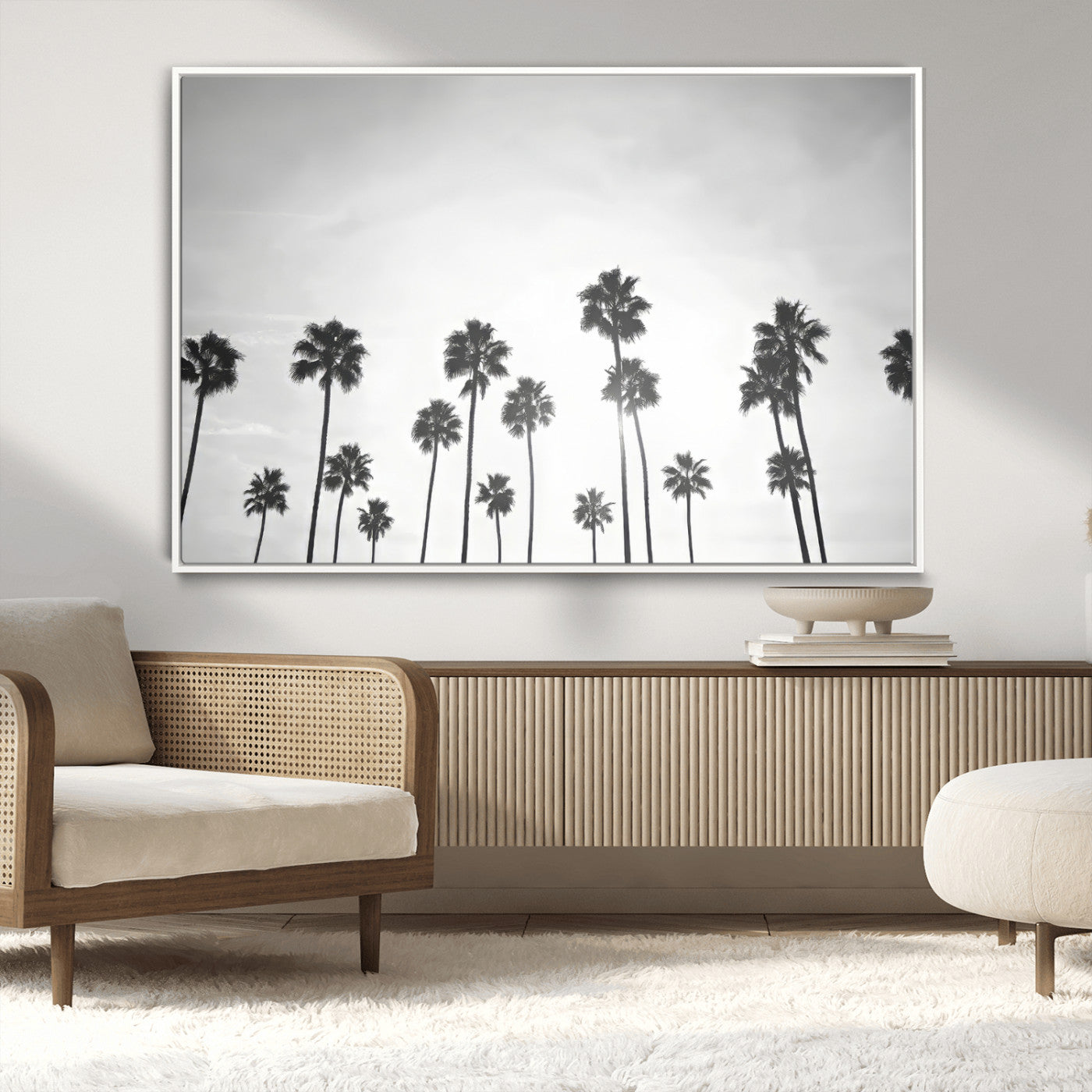 A black and white minimalist scene featuring tall palm trees silhouetted against a bright sky, creating a dreamy and timeless tropical aesthetic.