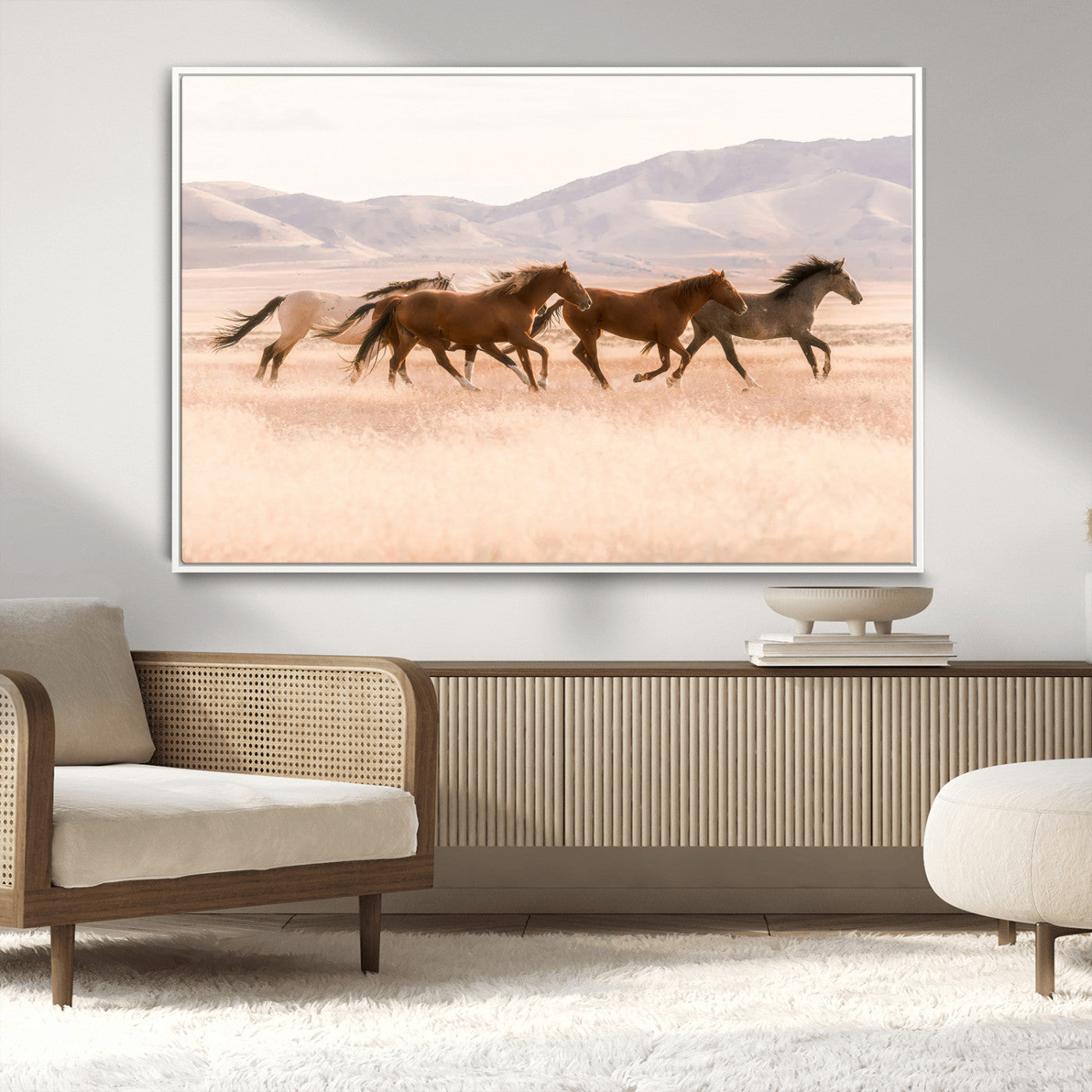 A herd of wild horses galloping through a sunlit desert plain with mountains in the background, perfect for rustic or western-themed wall decor.