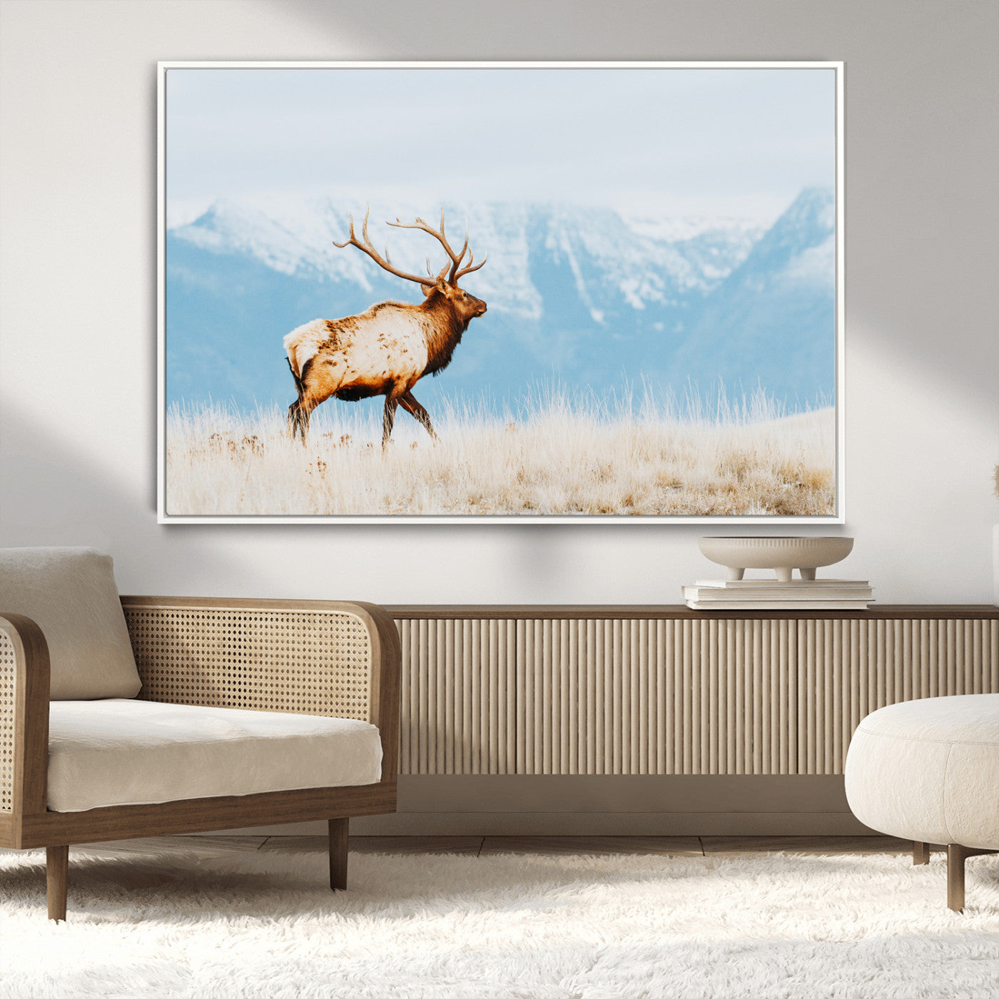 Majestic elk standing on dry grassland with snowy mountains in the background, ideal for rustic or lodge-inspired wall decor.