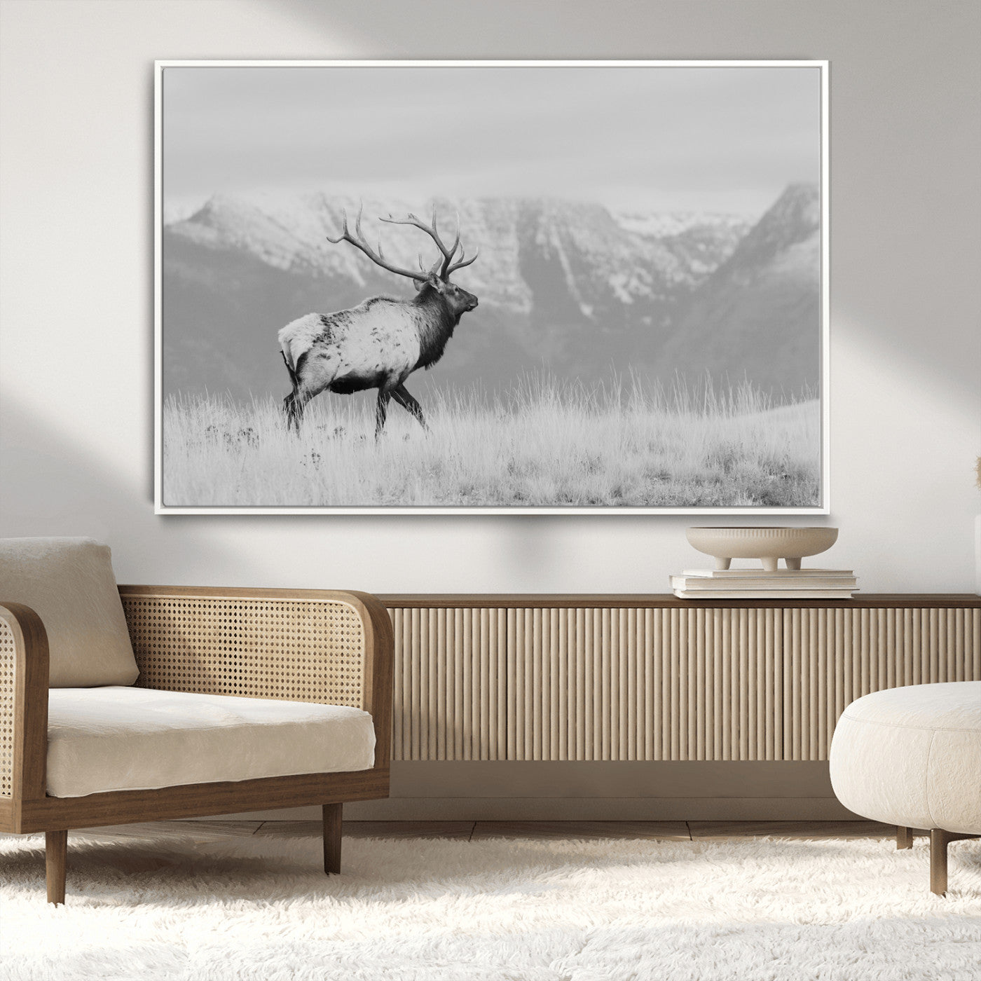 Black and white elk standing in front of snowy mountain range, perfect for rustic lodge or nature-inspired wall decor.