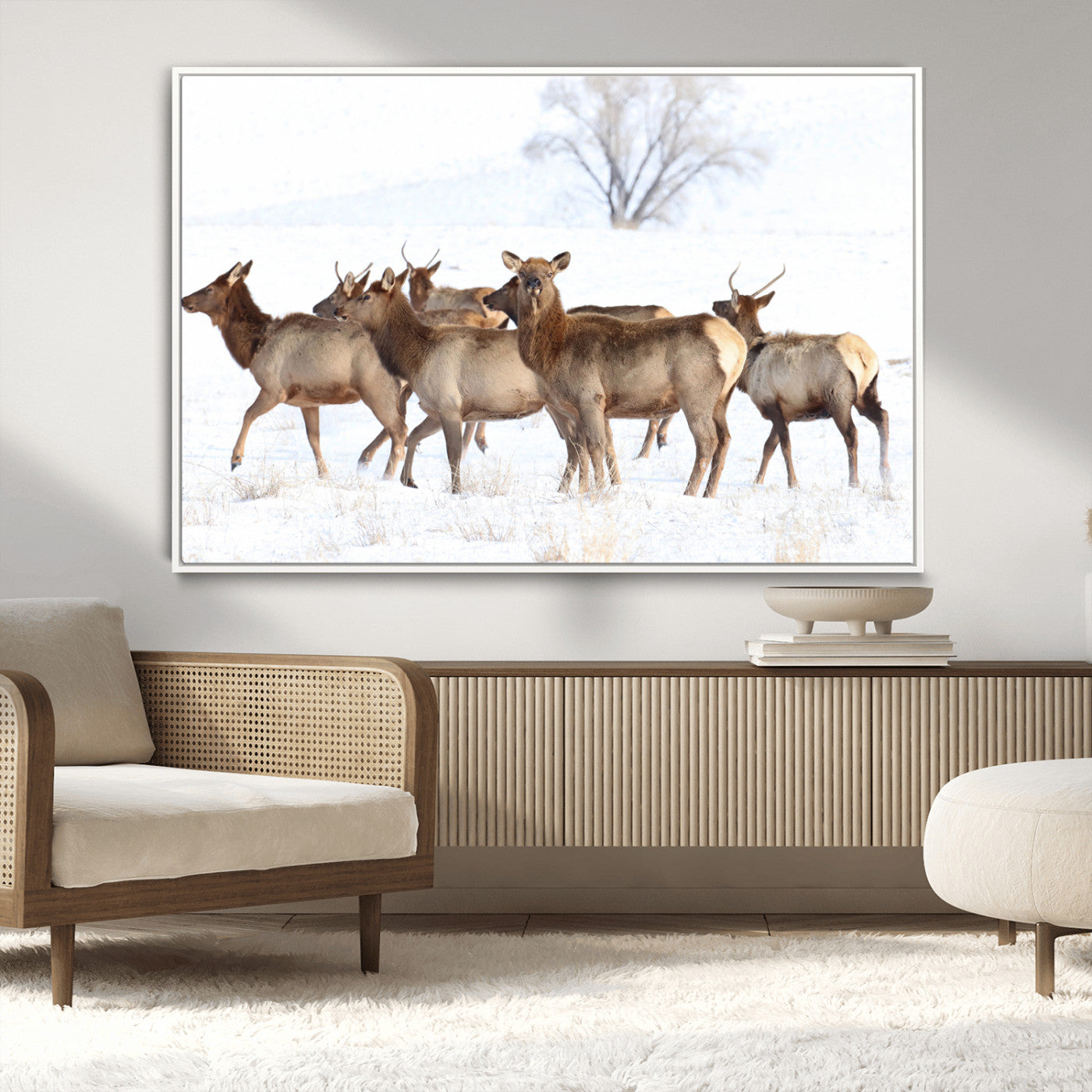 A group of elk standing on snowy terrain with a tree in the background, perfect for rustic or lodge-style winter wall decor.