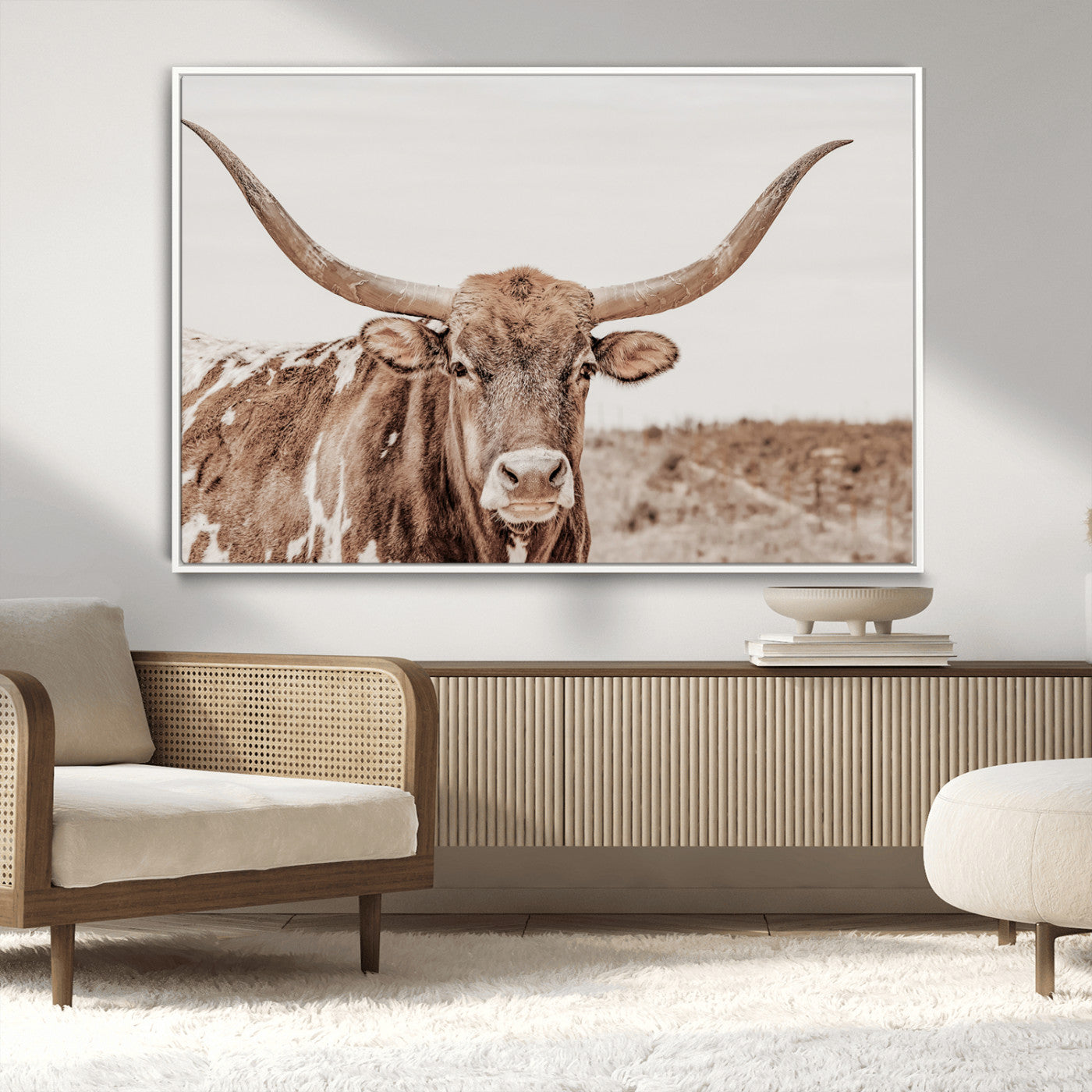 A longhorn cow in soft beige desert tones, standing calmly in open land, perfect for neutral western or rustic farmhouse interiors.