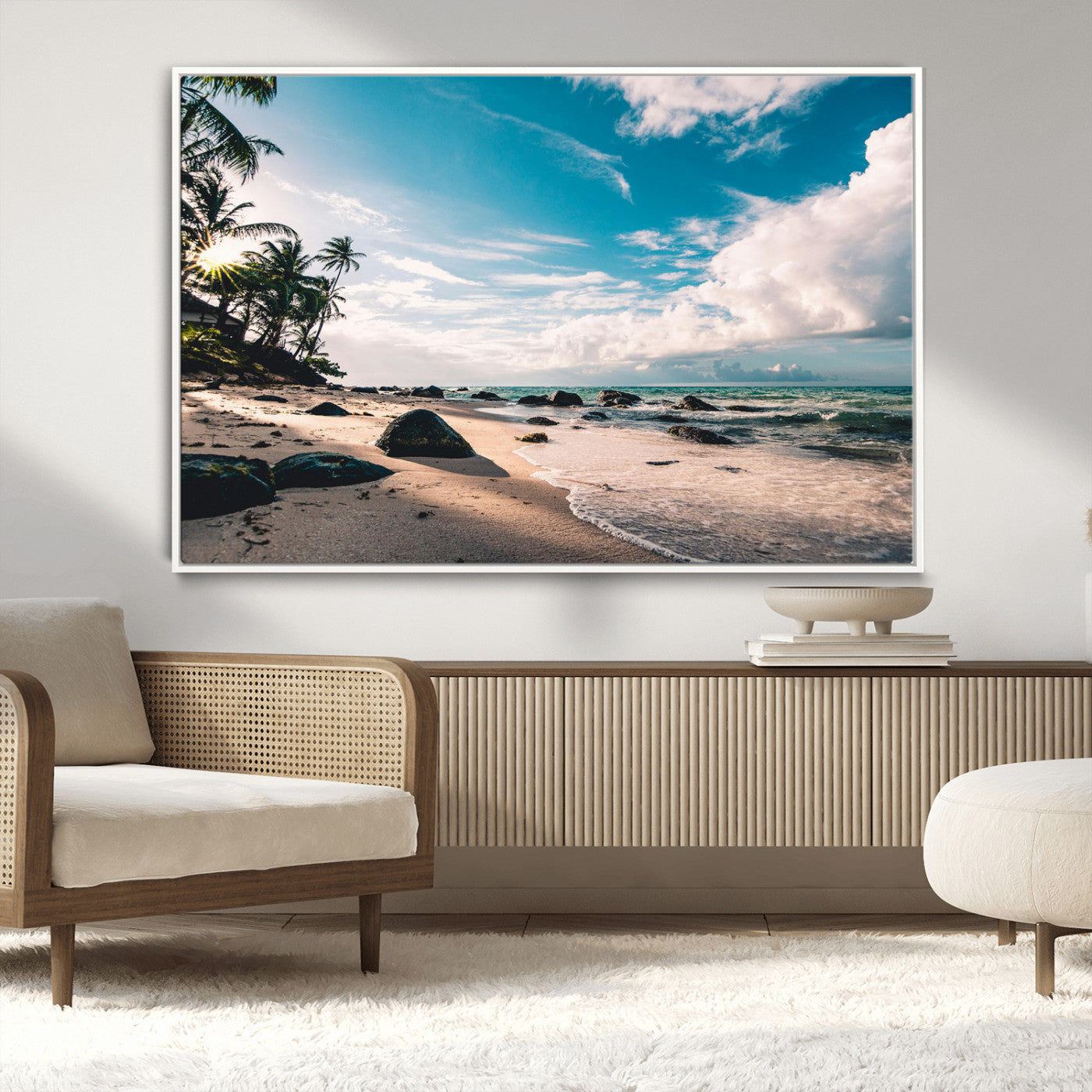 Scenic tropical beach with palm trees, ocean waves, and rocky shoreline under a bright blue sky, creating a serene coastal vibe.
