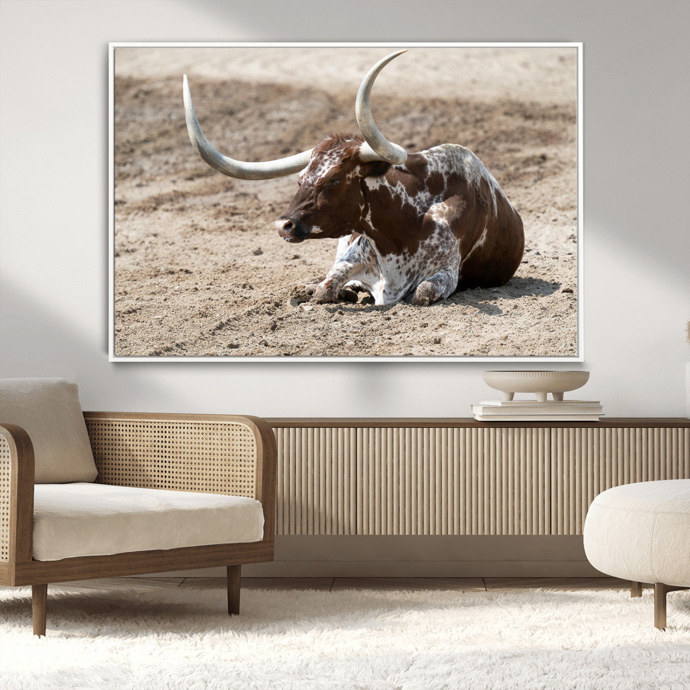 Texas Longhorn resting on sandy ground with large curved horns, capturing a rustic Western aesthetic perfect for farmhouse-style wall art.