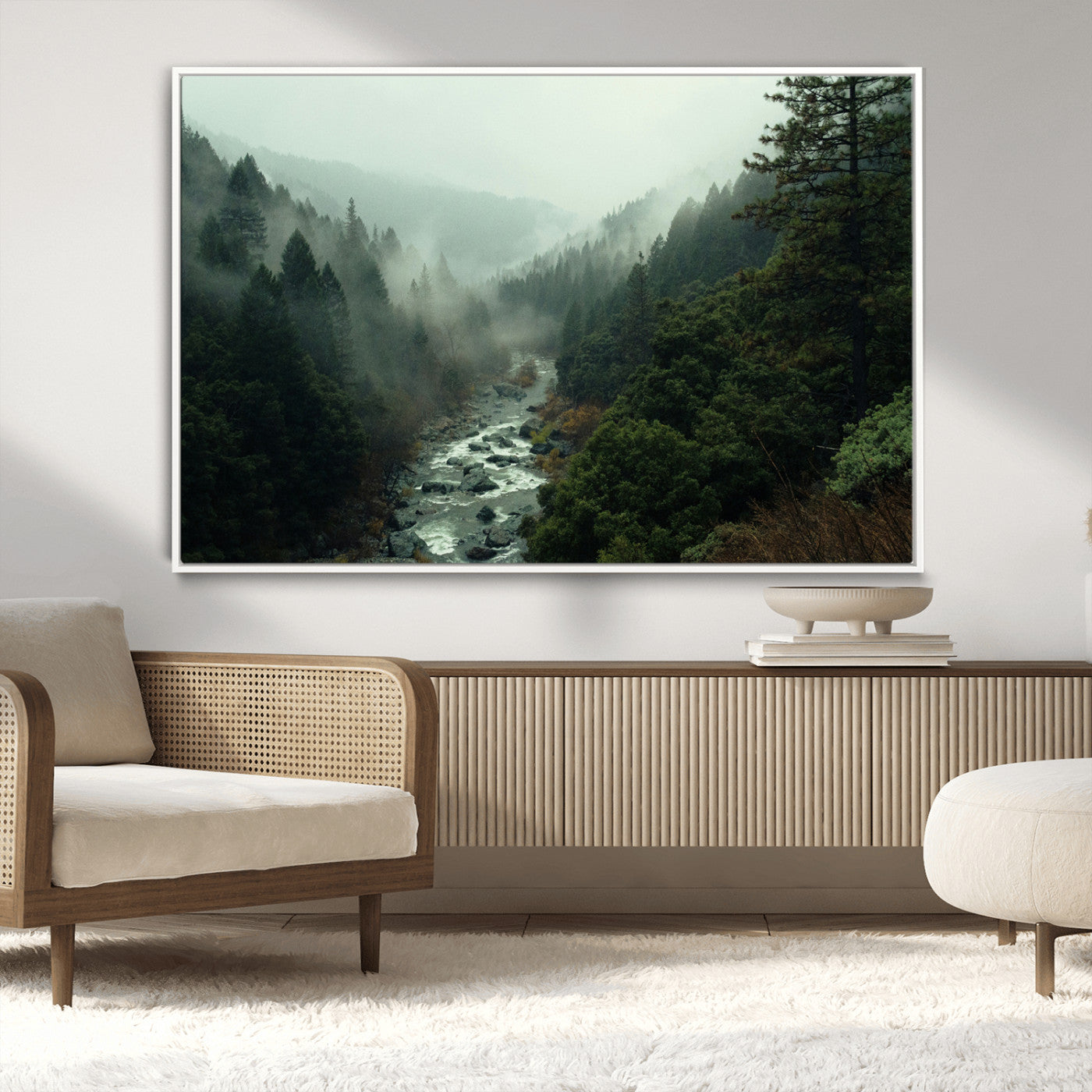 Misty forest with a winding river flowing through lush green mountains, creating a tranquil and moody wilderness landscape.