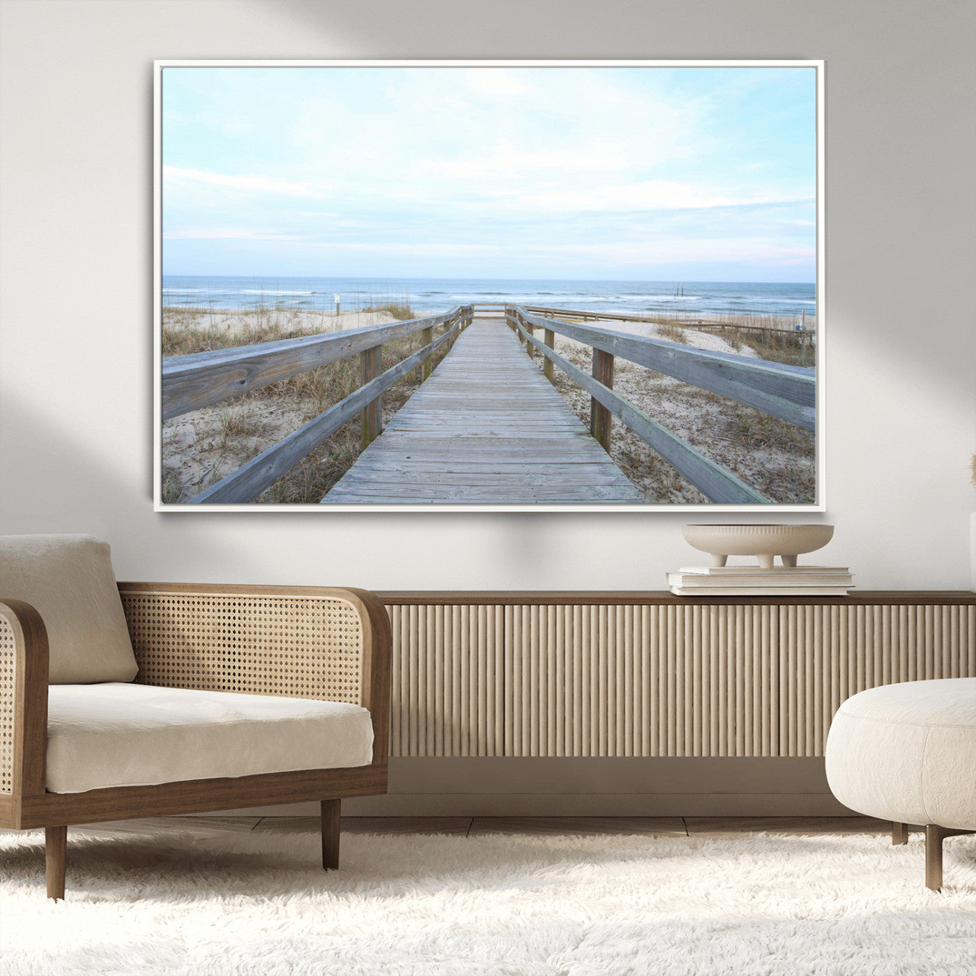 Wooden boardwalk leading to a peaceful beach with gentle ocean waves under a soft pastel sky, perfect for coastal and nautical home decor.
