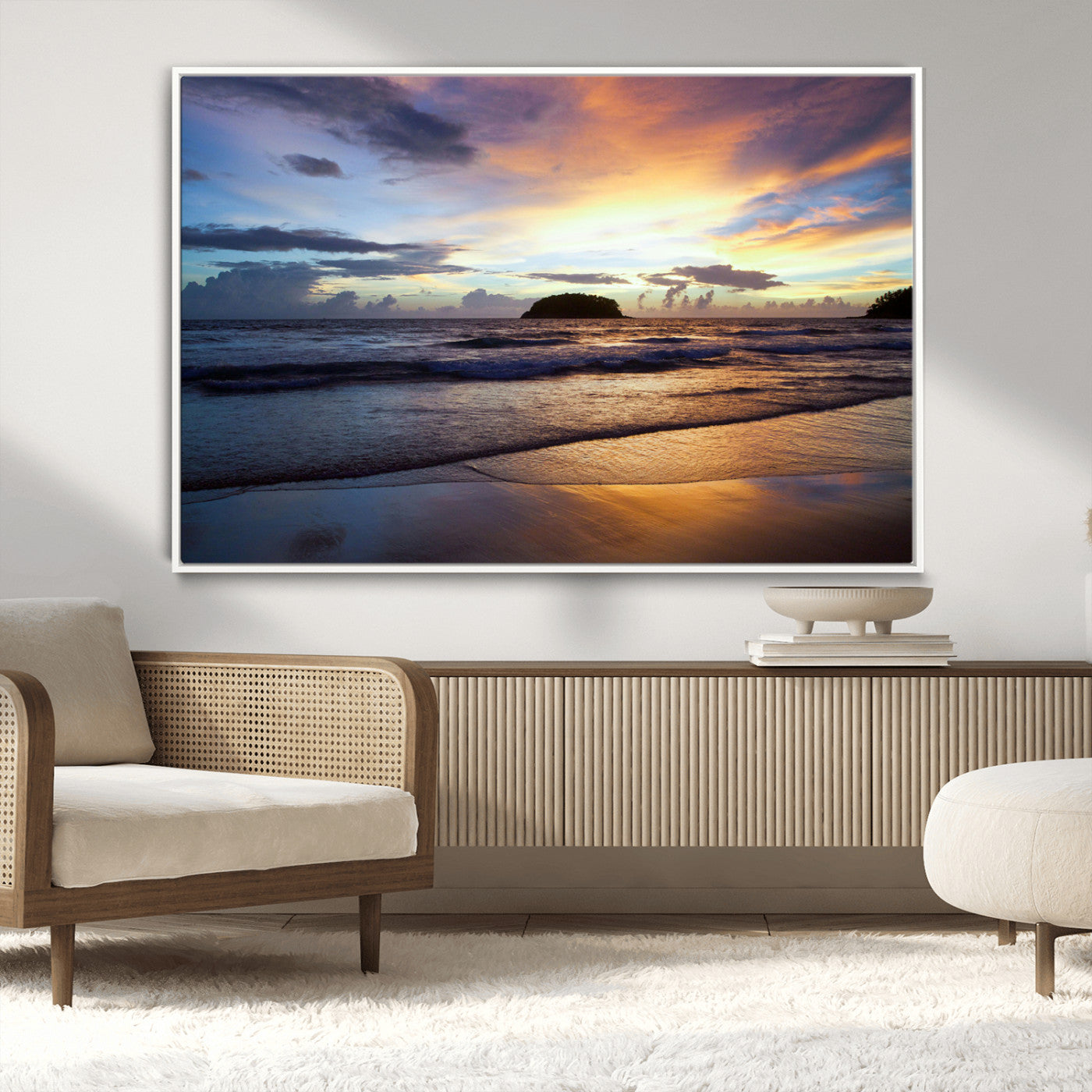 A tropical beach at sunset with waves gently washing ashore, reflecting golden and purple hues in the sky, creating a tranquil coastal scene.