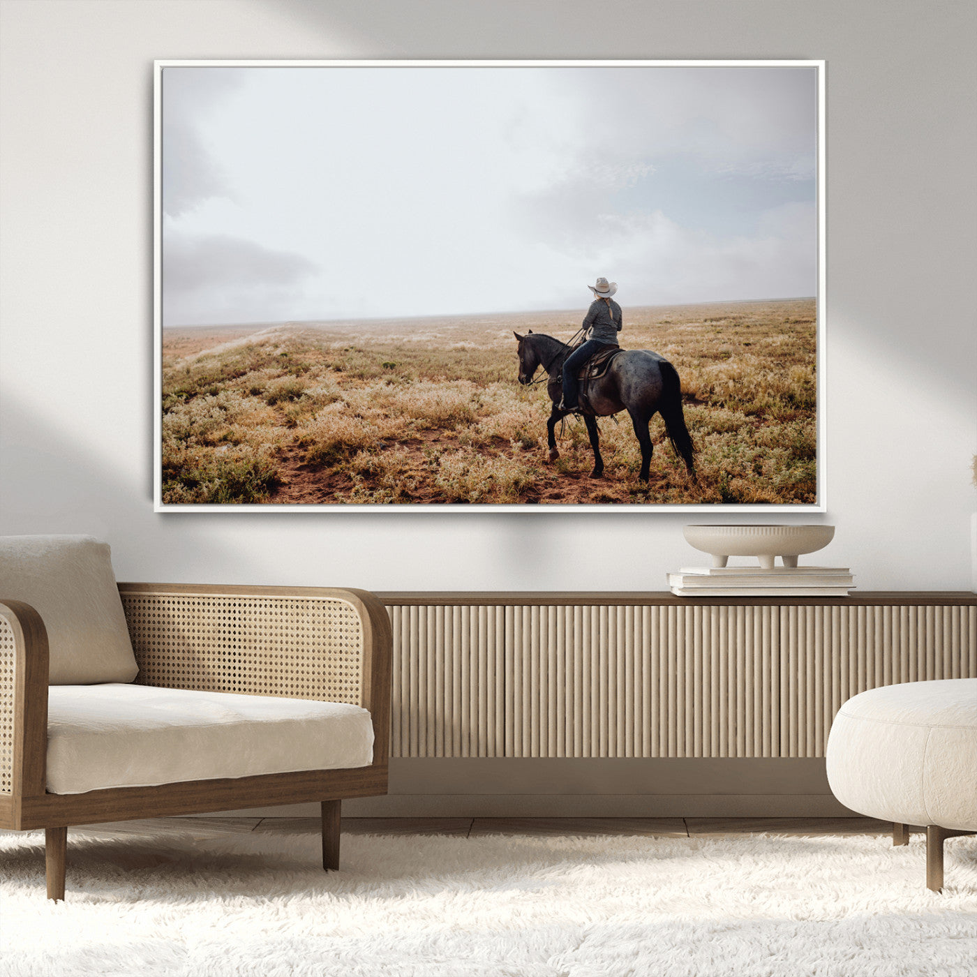 A lone cowboy riding horseback across an open prairie under a vast sky, capturing the rugged and timeless spirit of the Western frontier.