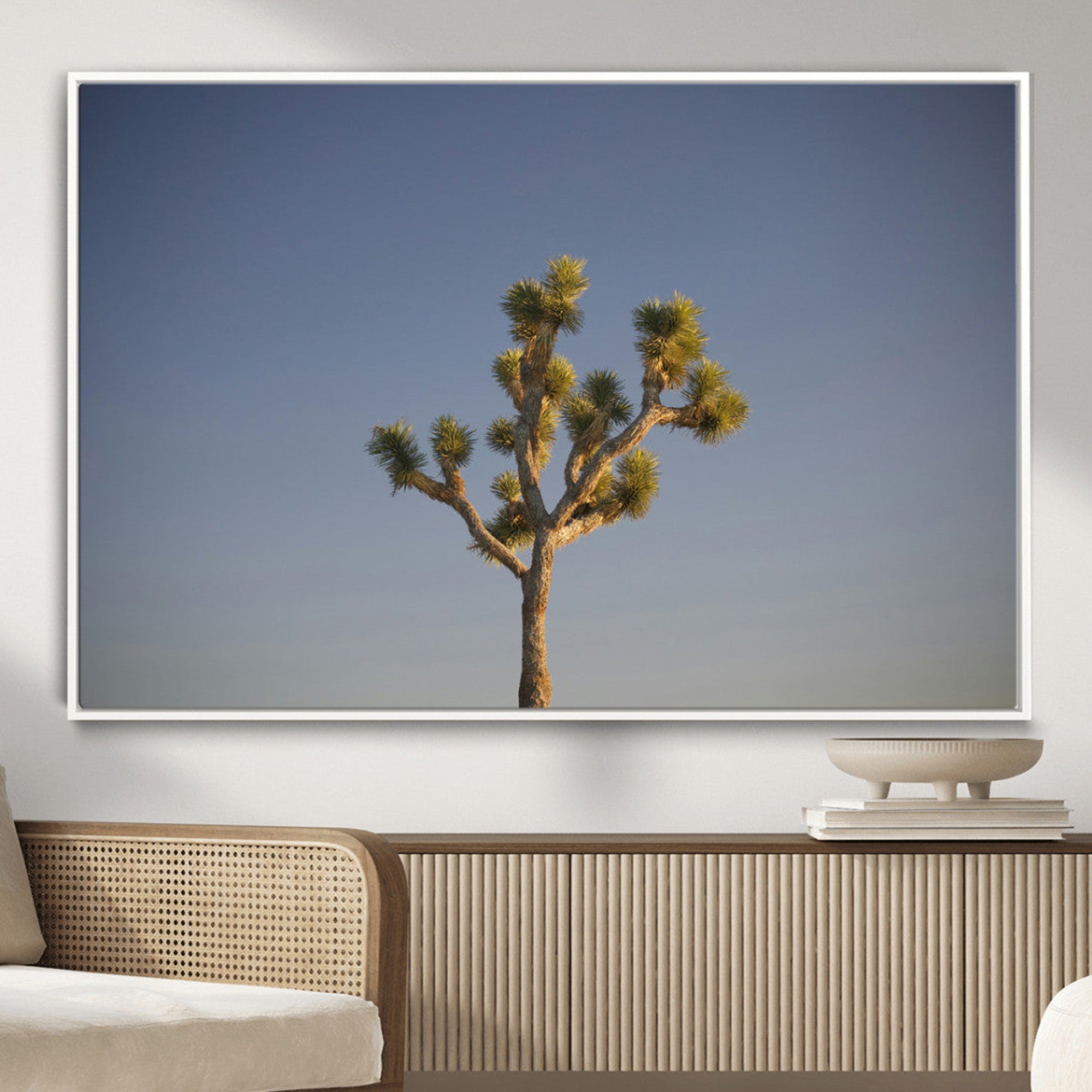 A lone Joshua Tree standing against a deep blue sky, capturing the serene and rugged beauty of the Southwestern desert landscape.