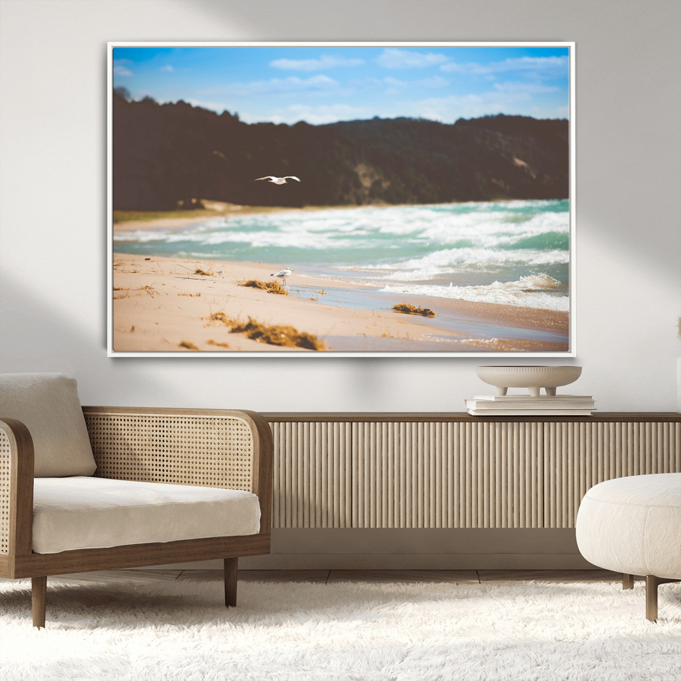 Serene beach scene with gentle ocean waves, sandy shore, and a seagull flying under a blue sky, perfect for coastal and nature-inspired decor.