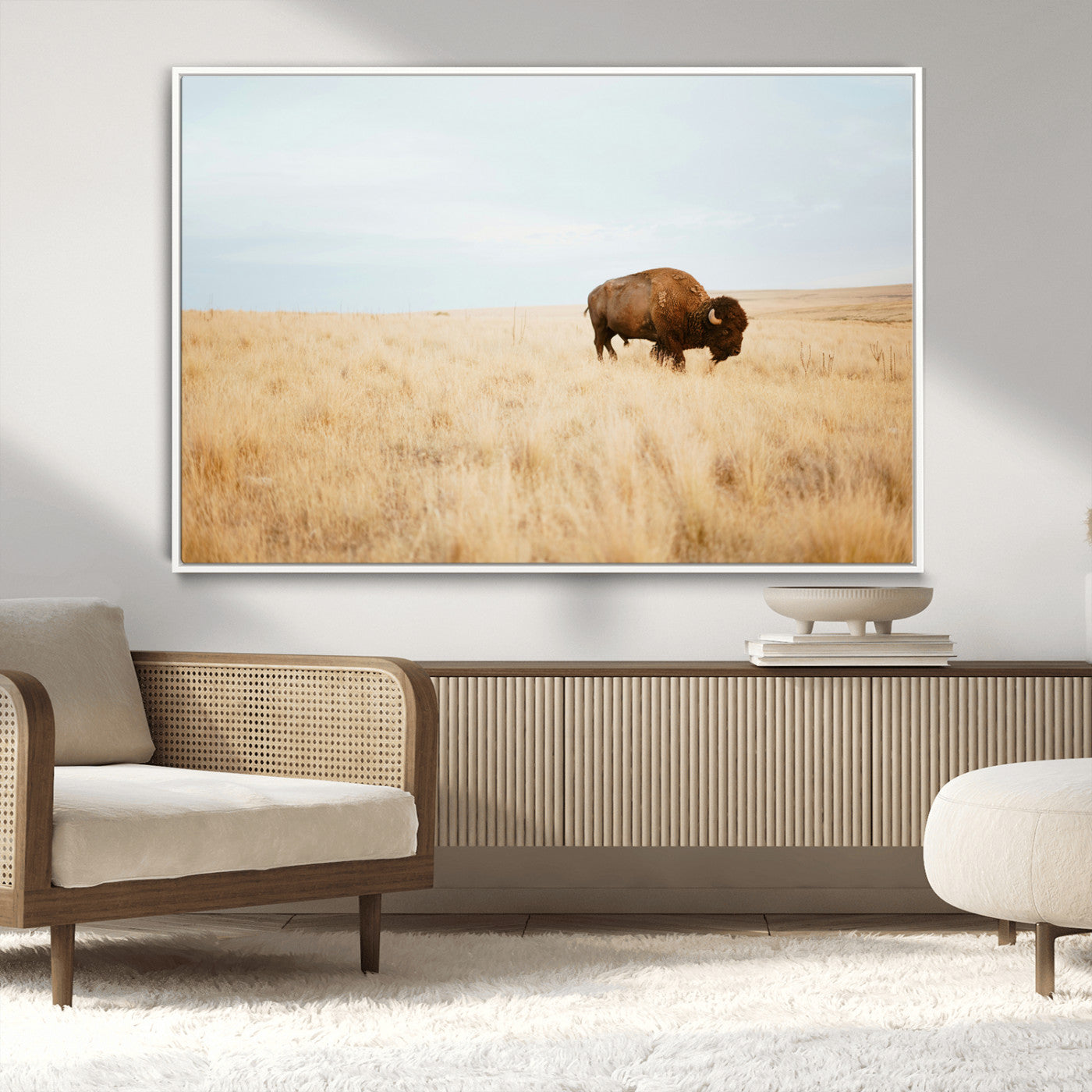 A lone bison standing in a vast golden grassland under a soft blue sky, evoking a rustic and Western aesthetic, ideal for farmhouse decor.