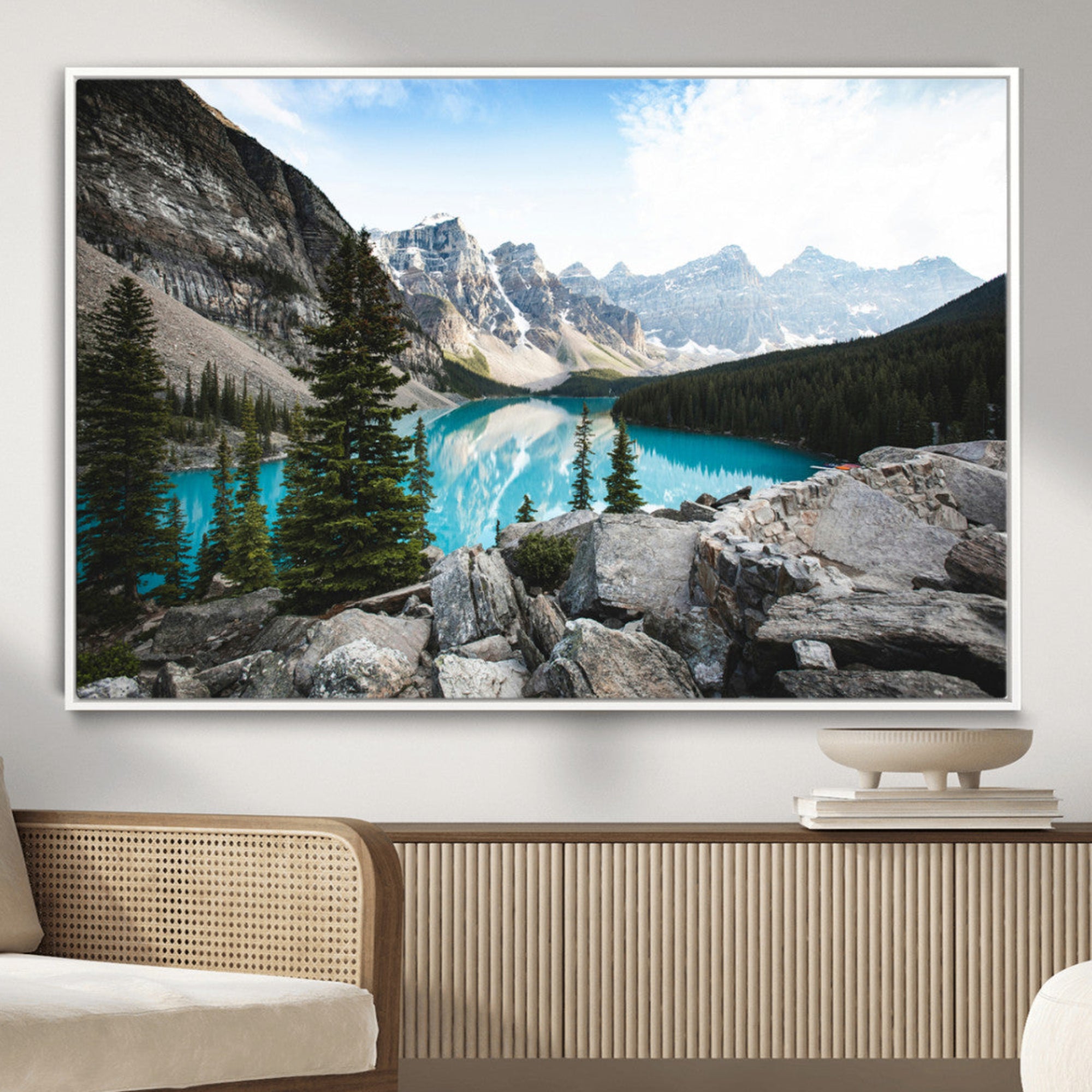 Stunning view of Moraine Lake with turquoise waters reflecting snow-capped mountains and evergreen trees, creating a peaceful alpine decor.