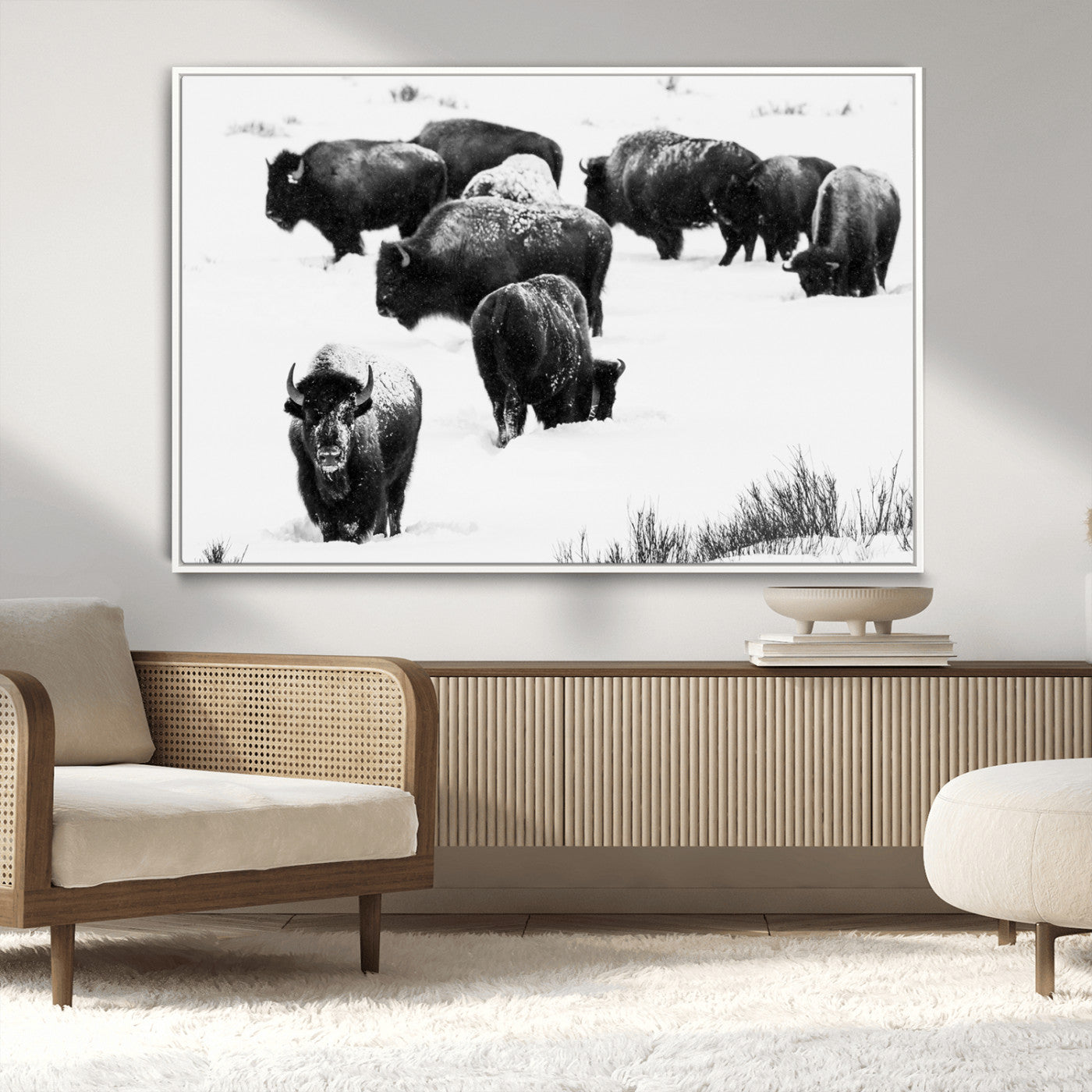 Black and white photograph of a bison herd in a snowy landscape, with snow-covered fur and a rugged wilderness setting, perfect for rustic lodge decor.
