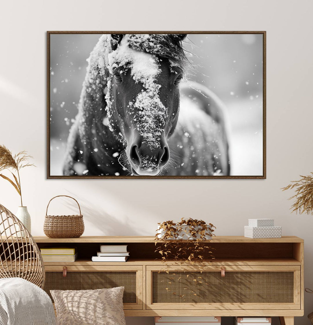 The Black and White Horse Winter Wall Art features a majestic horse with snow-covered hair set against a serene winter backdrop.