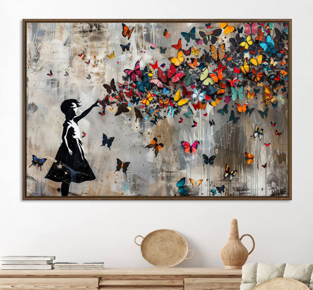 The Banksy Butterfly Girl 3-Piece Modern Graffiti Canvas Wall Art features a silhouette of a girl reaching for butterflies.